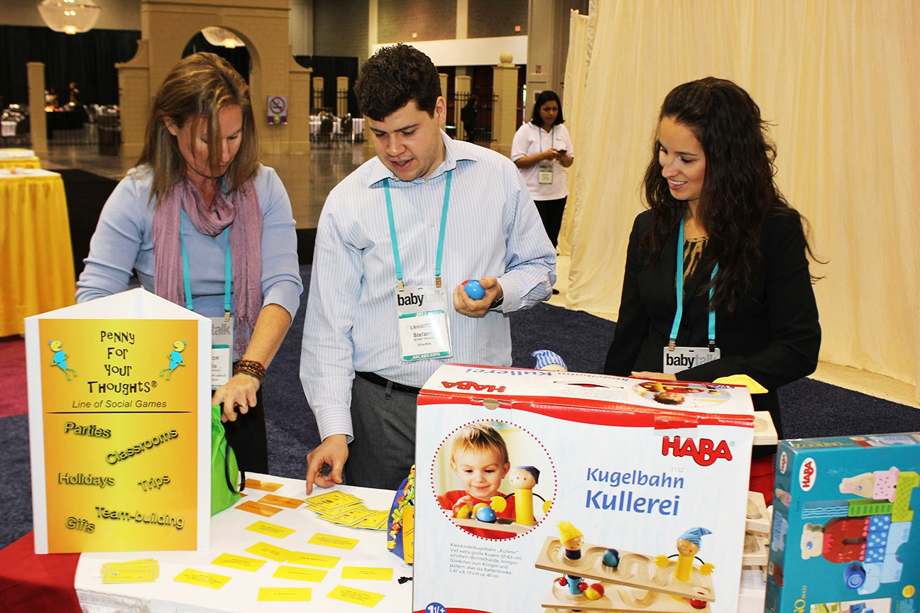 Exhibitors at ABC Kids Expo 2012, looking at products in The Toy Man® Pavillion